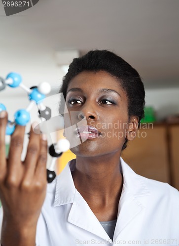 Image of Teacher Looking At Molecular Structure In Science Lab