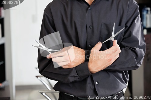 Image of Male Hairstylist Holding Two Scissors