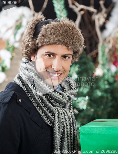 Image of Handsome Man With Gift Box In Store