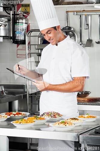 Image of Young Chef With Clipboard At Kitchen