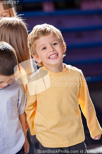 Image of Boy Looking Away With Friends In Kindergarten