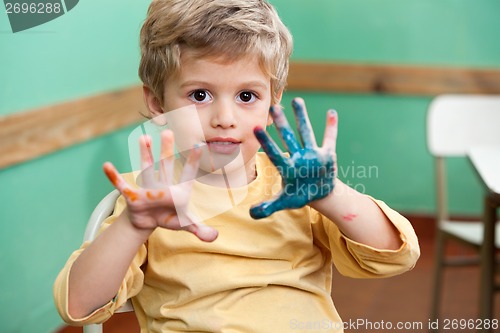 Image of Boy Showing Colored Palms In Art Class