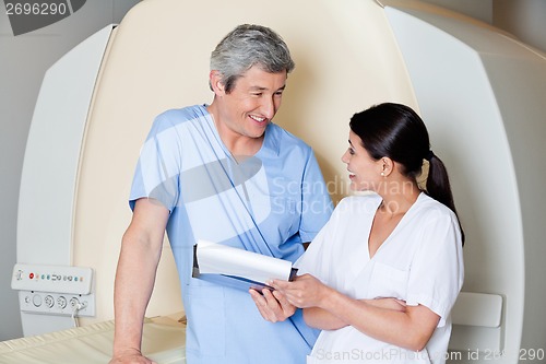 Image of Radiologic Technicians Smiling At Each Other