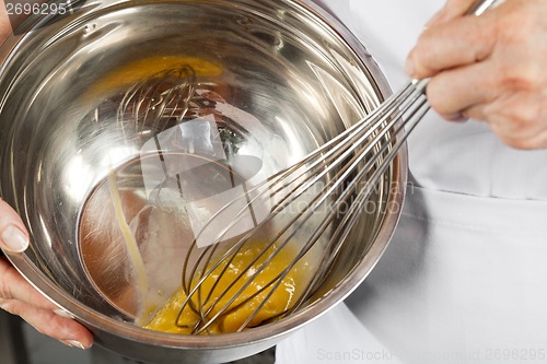 Image of Female Chef Beating Eggs With Wisk