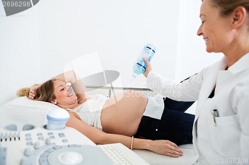 Image of Doctor Applying Gel On Pregnant Woman's Belly