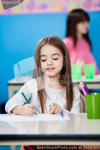 Image of Girl Drawing With Sketch Pen In Preschool