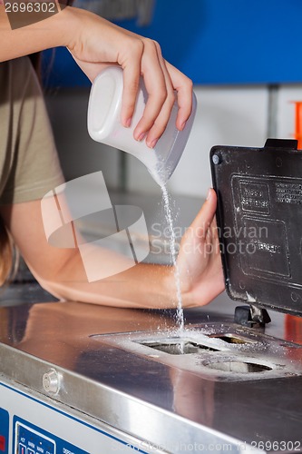 Image of Woman Pouring Detergent Powder In Washing Machine