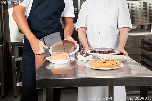 Image of Chefs With Sweet Dishes At kitchen Counter