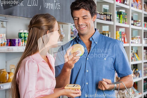 Image of Couple Buying Cheese In Store