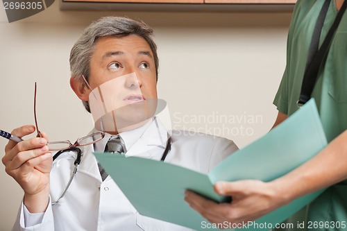 Image of Doctor Looking At Technician