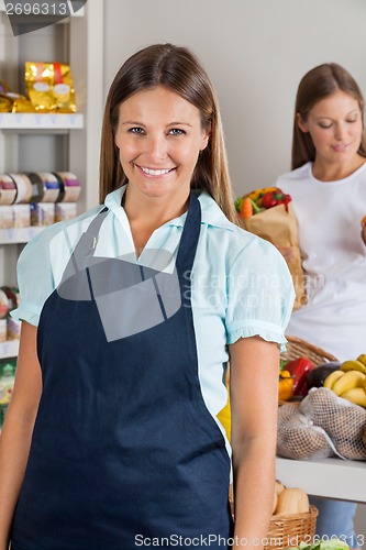 Image of Saleswoman With Female Customer In Background