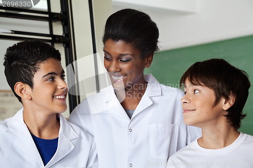 Image of Teacher Looking At Schoolboy In Science Lab