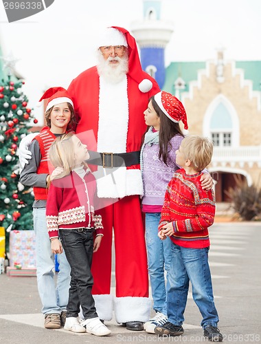 Image of Santa Claus With Children Standing In Courtyard