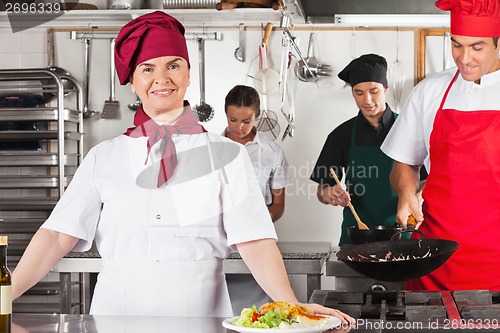 Image of Confident Female Chef In Kitchen