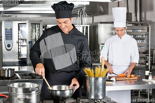 Image of Professional Chefs Preparing Spaghetti