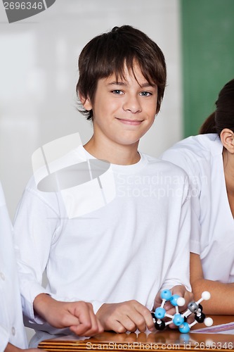 Image of Teenage Schoolboy With Molecular Structure At Desk