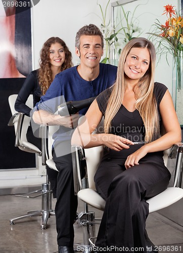 Image of Confident Team Of Hairstylists At Beauty Parlor