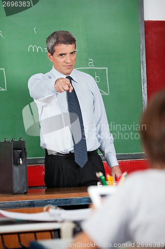 Image of Male Teacher Pointing At Schoolboy