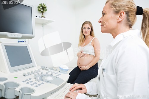 Image of Gynecologist Using Ultrasound Machine