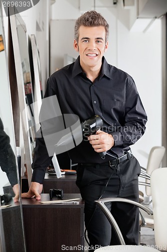 Image of Happy Male Hairdresser With Hairdryer