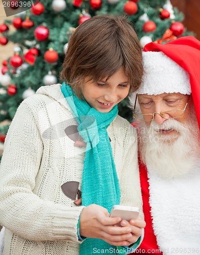 Image of Boy Showing Smartphone To Santa Claus