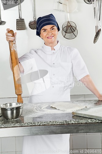 Image of Female Chef With Rolling Pin By Kitchen Counter