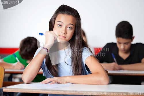 Image of Teenage Schoolgirl Sitting At Desk