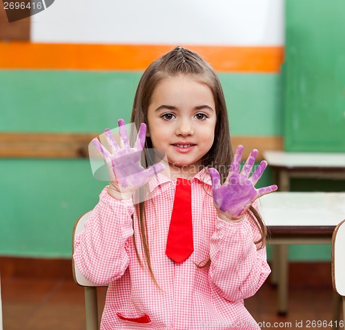 Image of Girl Showing Colored Palms With Friends In Background