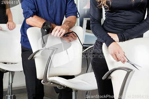 Image of Hairdressers With Dryer And Scissors