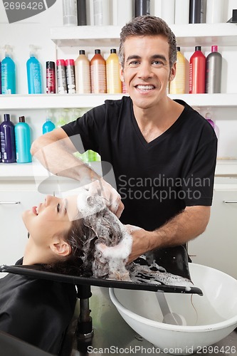 Image of Hairstylist Washing Customer's Hair At Salon