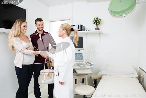 Image of Gynecologist Greeting Happy Young Couple