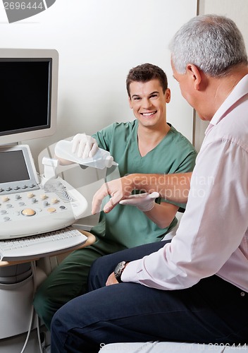 Image of Technician Putting Gel On Patient's Hand