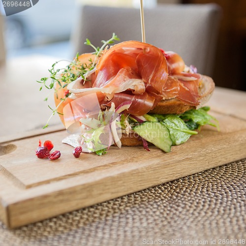 Image of Parma Ham Sandwich On Wooden Plate