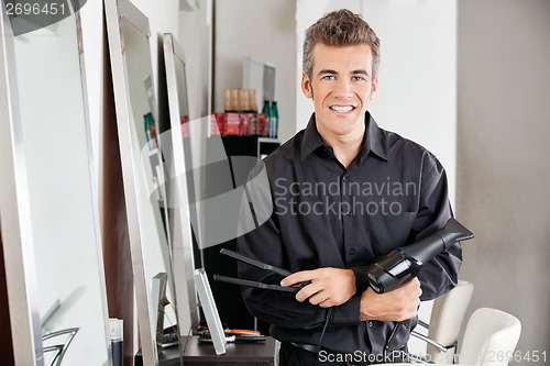 Image of Male Hairstylist With Hairdryer And Straightener