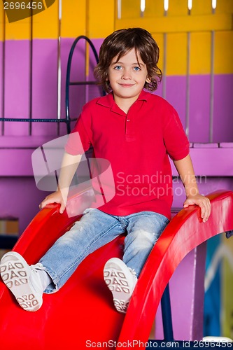 Image of Little Boy Playing On Slide In Kindergarten