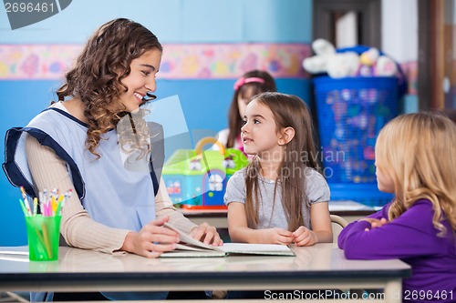 Image of Teacher Teaching Little Girls In Classroom