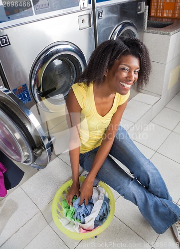 Image of Young Woman With Laundry Basket