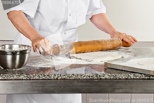 Image of Female Chef Rolling Dough