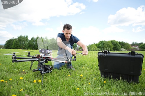 Image of Technician Fixing Propeller Of UAV Helicopter