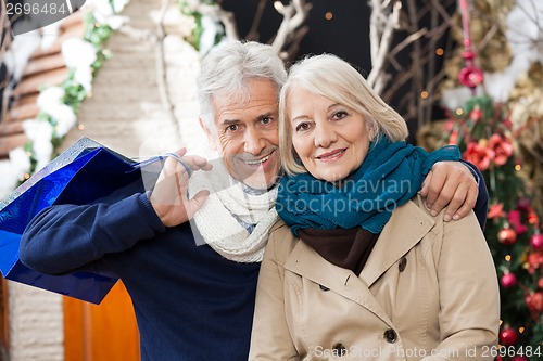 Image of Couple With Shopping Bags At Christmas Store