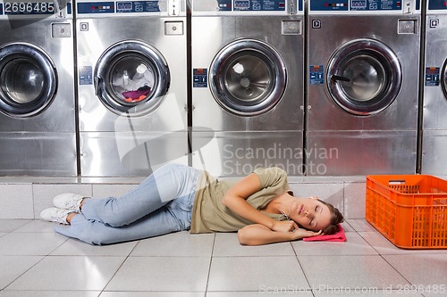 Image of Woman Listening Music While Resting In Laundry