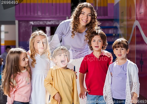 Image of Teacher With Group Of Children In Preschool