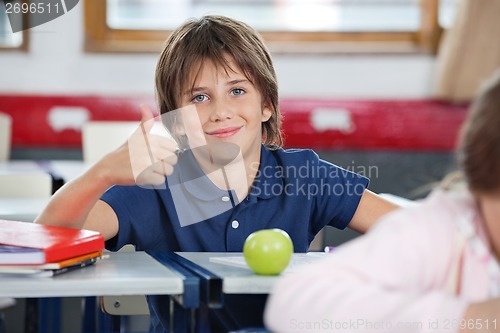 Image of Boy Gesturing Thumbs Up In Classroom