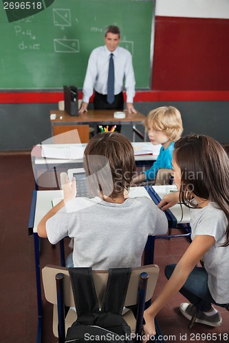 Image of Students Using Digital Tablet At Desk