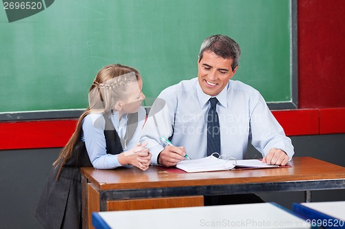 Image of Male Teacher Explaining Lesson To Schoolgirl