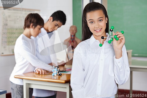 Image of Teenage Schoolgirl Holding Molecular Structure