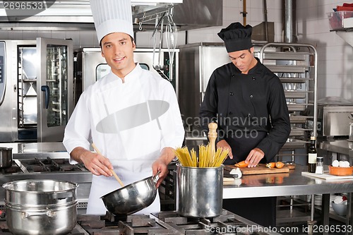 Image of Young Chef Preparing Spaghetti