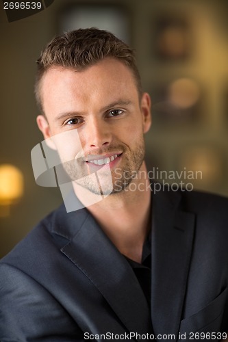 Image of Young Businessman Smiling In Restaurant