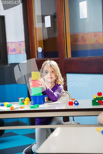 Image of Girl Playing With Toys In Kindergarten