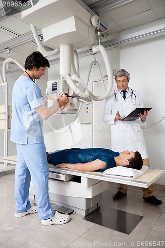 Image of Radiologists Performing X-ray On Patient